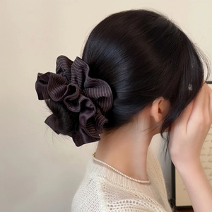 Detail of dark brown striped scrunchie showing the soft pleated silk texture on hair