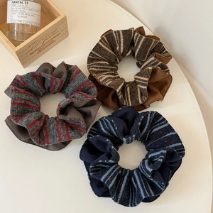 Three-piece set of striped knit scrunchies in brown, grey, and blue colors