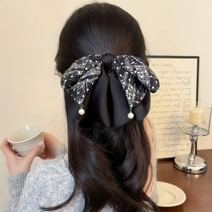 Elegant large tweed and satin bow hair clip with white pearl pendants on black hair
