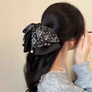 Elegant large black and white plaid bow hair claw clip with pearls on long hair