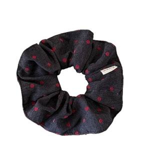 Blue denim scrunchie with red polka dots and white Hand Made label for ponytails