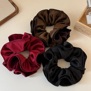 Three elegant large velvet scrunchies in burgundy, dark brown and black colors