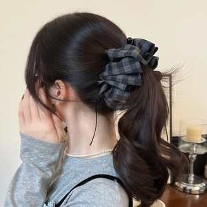 Elegant black and grey plaid fabric scrunchie with voluminous pleated texture design