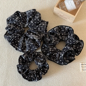 Three-piece black and white patterned hair scrunchies with polka dots and grid texture
