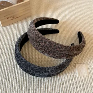 Detail of leopard print velvet headbands in brown and grey with soft textured finish