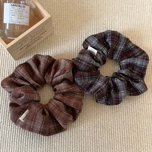 Plaid scrunchies set in brown and blue grey with handmade tags for ponytail styling