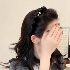 Elegant velvet twisted headband with gold logo and pearl on brunette model hair