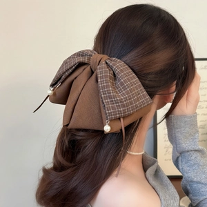 Brown plaid layered bow hair claw clip with pearl pendants shown on half-up hair