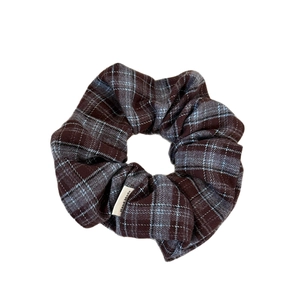 Brown and blue plaid scrunchie with handmade label for stylish ponytail styling