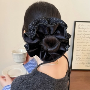 Chic multi-layered velvet polka dot scrunchie styled on a bun hairstyle for a fashionable look