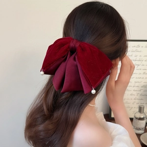 Elegant red velvet bow hair clip with faux pearl charms for sophisticated hairstyles