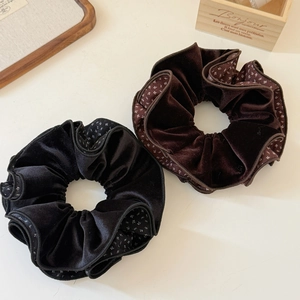 Elegant velvet scrunchies in black and coffee brown with floral piping on white background