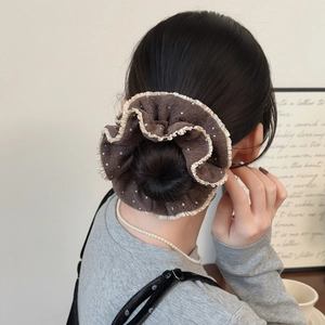 Elegant brown polka dot scrunchie with lace trim shown on a stylish hair bun