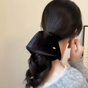 Elegant black velvet oversized bow hair claw clip with golden metal accent for women