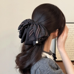 Vintage floral bow hair claw with pearl pendants and paisley pattern on black satin fabric