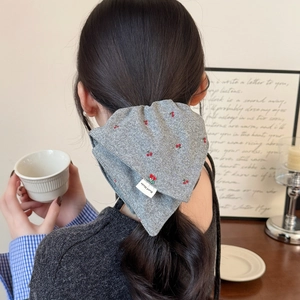 Knitted grey hair scrunchie with red cherry embroidery and handmade label on ponytail