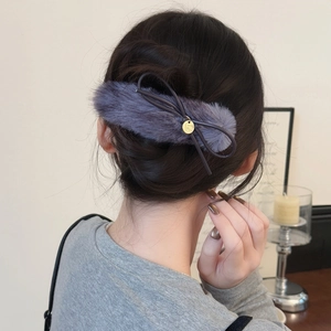 Plush faux fur bow hair clip in dark grey with a golden metal charm for women