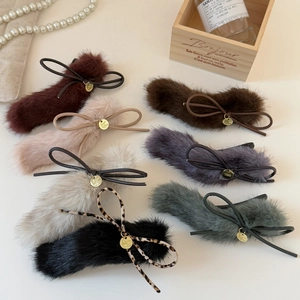 Elegant plush bow hair clips in multiple colors with golden metal charms and ribbons