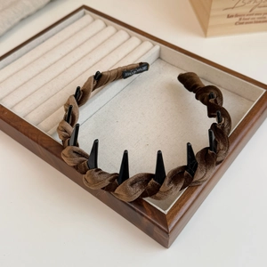 Detail of coffee velvet twisted headband showing anti-slip teeth and handmade inner label