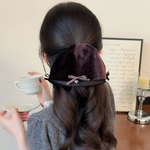Elegant large brown velvet bow hair clip with silver heart pendant on a model ponytail