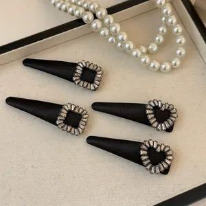 Elegant four-piece black rhinestone hair clip set with heart and square crystal designs