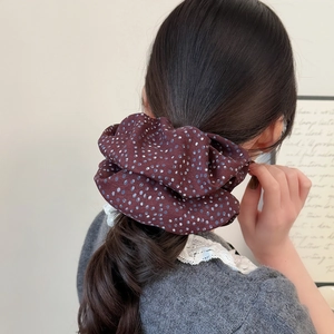 Minimalist oversized dark brown polka dot scrunchie shown in a stylish ponytail hairstyle
