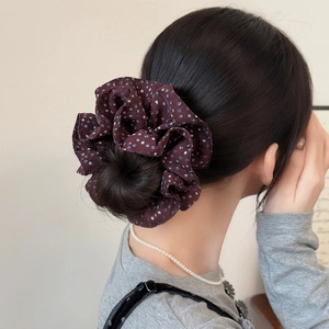 Polka dot oversized scrunchie in burgundy red chiffon worn on a bun hairstyle