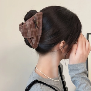 Maillard brown plaid bow claw clip for elegant women hair styling on dark hair
