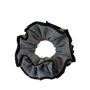 Elegant grey knitted scrunchie with refined black lace edges for ponytail styling