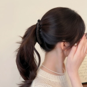 Minimalist black matte banana hair clip holding a high ponytail for elegant styling