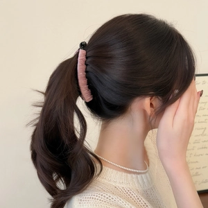 Pink pleated fabric banana hair clip worn on ponytail with elegant minimalist design