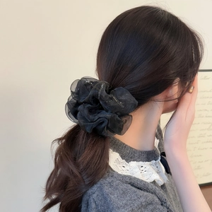Elegant large black tulle scrunchie with silver glitter on low ponytail hairstyle