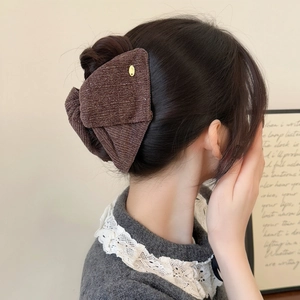 Elegant dark brown glitter velvet bow hair claw clip worn on hair for a vintage look
