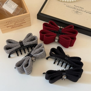 Detail of elegant knit bow hair clips with rhinestones in burgundy, grey, and black