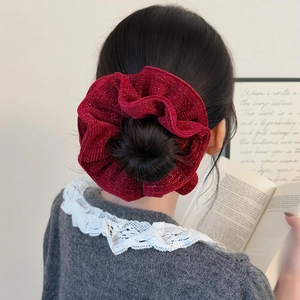 Elegant wine red sparkly knit scrunchie for hair styling in a classic bun hairstyle