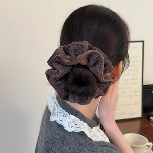 Sparkly dark brown oversized scrunchie for women shown on a bun hairstyle with glittery texture