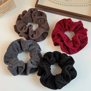 Set of four shimmering knit scrunchies in brown, burgundy, dark grey and black colors