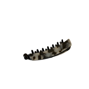 Large acetate banana hair clip with black and white marble pattern on white background