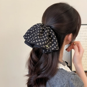 Polka dot paisley print hair claw clip for women featuring elegant black oversized bow design