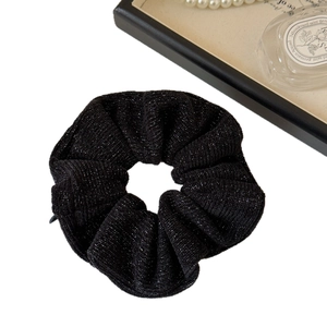 Elegant black tweed scrunchie with silver glitter thread for chic ponytail styling