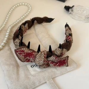 Detailed view of autumn winter bow headband with plaid fabric and plush faux fur texture