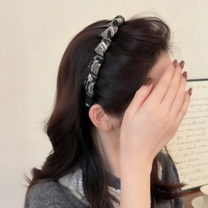 Elegant black and white tweed non-slip headband for women shown on a model