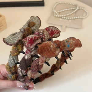 Close-up of vintage tweed bow headbands with inner teeth for secure hair styling
