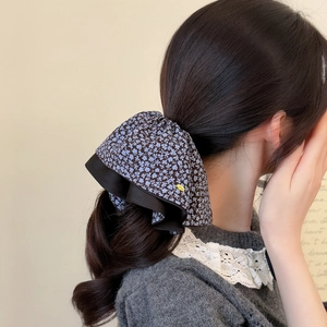Floral hair scrunchie with blue pattern and double-layered wave edge on ponytail
