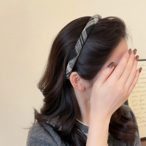 Close-up of elegant black and grey plaid knit headband on a model for a chic style