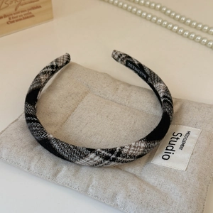 Detailed view of handmade plaid headband fabric texture with woven inner handmade label