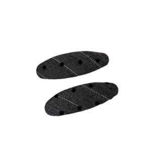 Set of two dark grey polka dot oval hair clips with white decorative stitching on white background