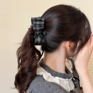 Detail showing vintage plaid bow banana clip holding a high ponytail for women