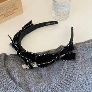 Elegant black velvet bow headband with polka dot edges and handmade craftsmanship