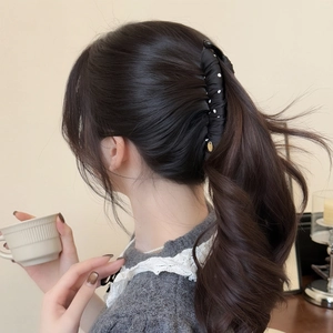 Elegant black polka dot bow banana hair clip for a voluminous ponytail hairstyle